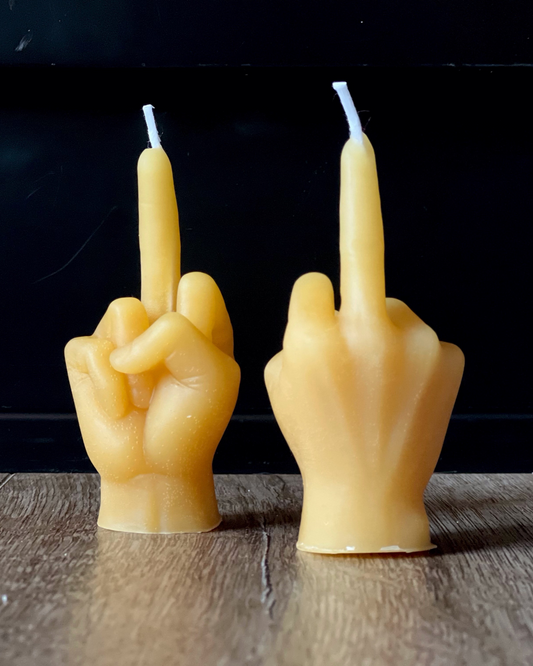A 100% beeswax candle in the shape of a 3.5" hand giving the middle finger